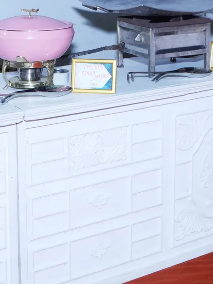 A close-up of our elegant pink chafing dishes on a white counter, ready for service. Even the serving equipment is chosen to complement the event's aesthetic.