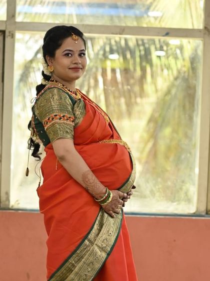 A lovely outdoor shot of the mom-to-be. The natural light shows off her glowing skin and the soft, elegant makeup.