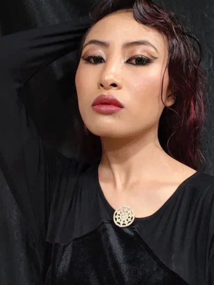 A confident pose that captures the edgy and contemporary feel of the glossy makeup look.