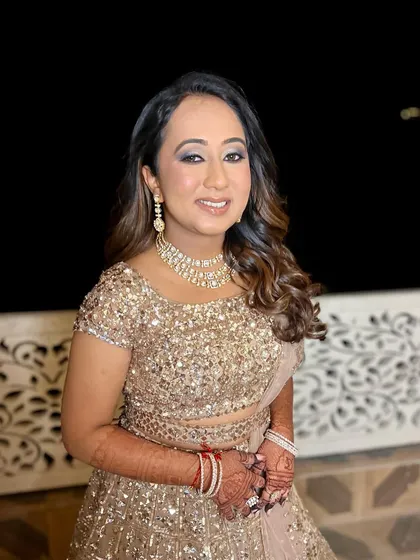 A happy and confident bride, ready for her Sangeet performance. Her makeup is designed to be picture-perfect from every angle.