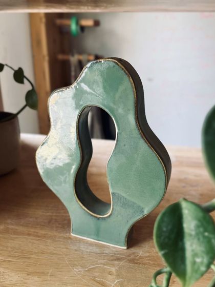 An abstract, sculptural vase with a cutout, showcasing the creative possibilities of hand-building.