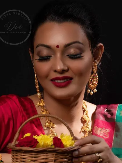 A festive glow for any occasion. This look features a classic red lip, soft gold eyeshadow, and traditional jewellery, perfect for celebrating in style.