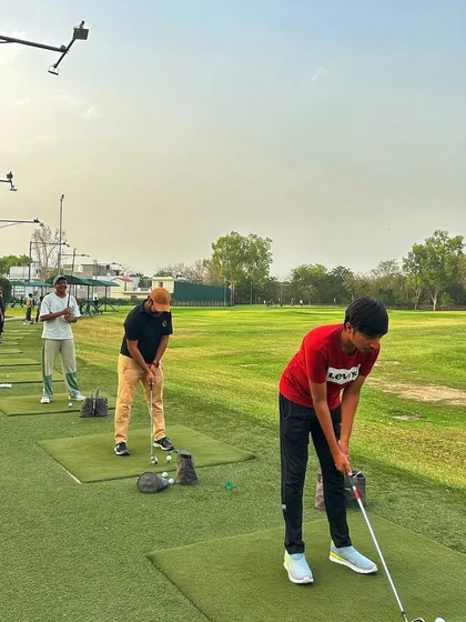 A line of young golfers getting their practice in, showing the future of the sport is bright.