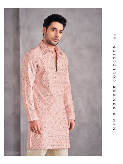 Soft hues, bold style. This pastel pink kurta from our Men's Summer Collection '25 features a unique open-collar design and intricate geometric embroidery.