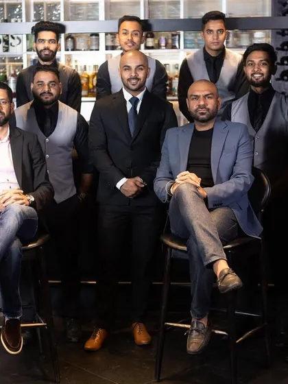Crafting the perfect cocktail, one sip at a time. Our expert mixologists, the heart and soul of Lair, pose for a team photo at the bar.