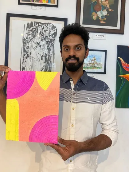 A participant with his colorful abstract texture painting. The workshop is a great way to explore color theory and composition.