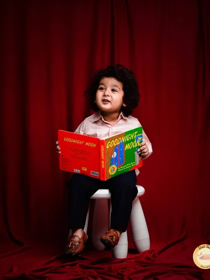 A quiet moment with a good book. This "little scholar" theme is a sweet and unique way to capture a child's curious and thoughtful side.