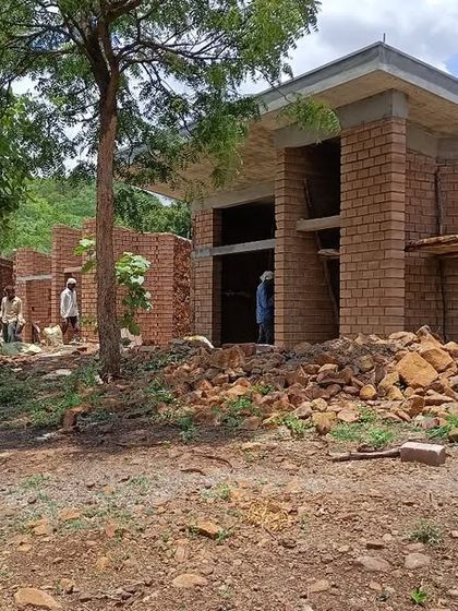 The Gamaya villas under construction, with walls of exposed brick and local stone. The building is nestled among existing trees, which we always strive to preserve as part of the site's natural heritage.