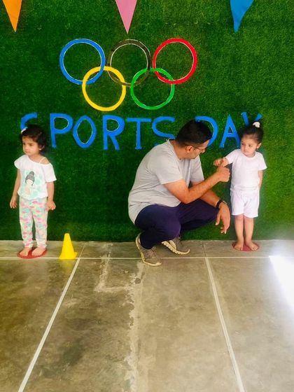 I provide one-on-one instruction to a three-year-old at the starting line of a race. For our youngest participants, my focus is on encouragement and making sure they feel safe and supported.