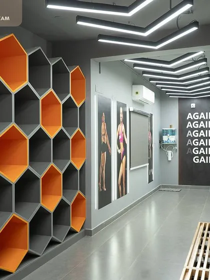 Function meets art in this custom storage solution for Robur Fitness Hub. We designed these honeycomb-style shelves to be a visually striking feature wall while providing practical, open storage for gym members. The orange accents add a pop of brand color to the space.