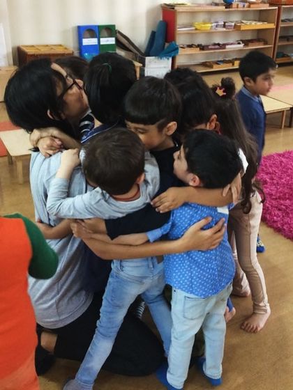 A group hug is the best kind of hug. Our teachers, like this one, create a space where children feel safe and loved.