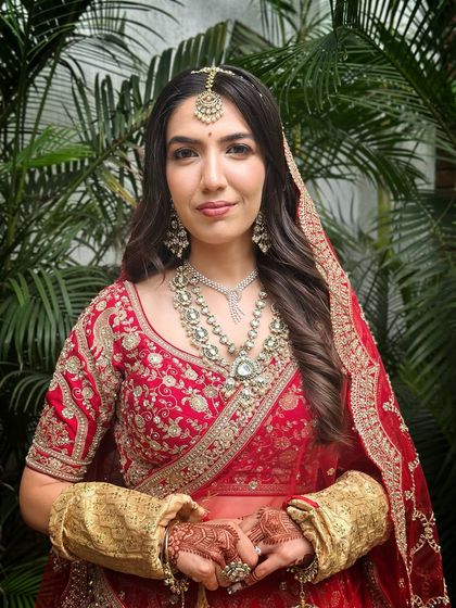 A candid moment, her hands adorned with henna, and her makeup looking serene and beautiful.