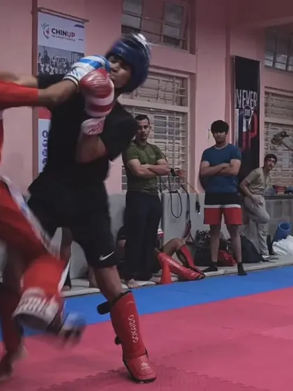 An explosive moment as a fighter lands a punch during a heated exchange. This is the culmination of countless hours of pad work and sparring drills.