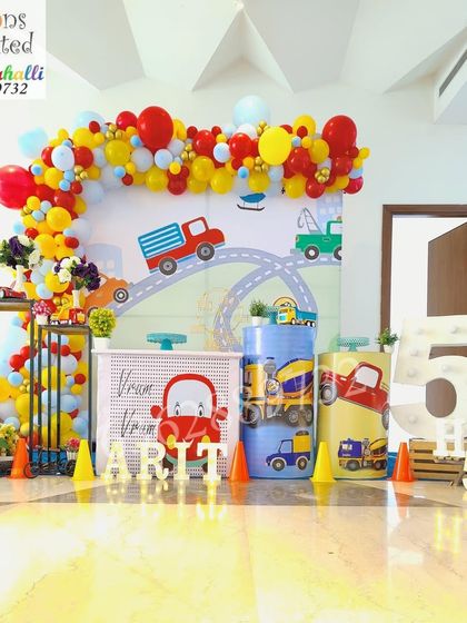 A wide shot of the vibrant car and truck themed birthday party, perfect for a spacious venue.