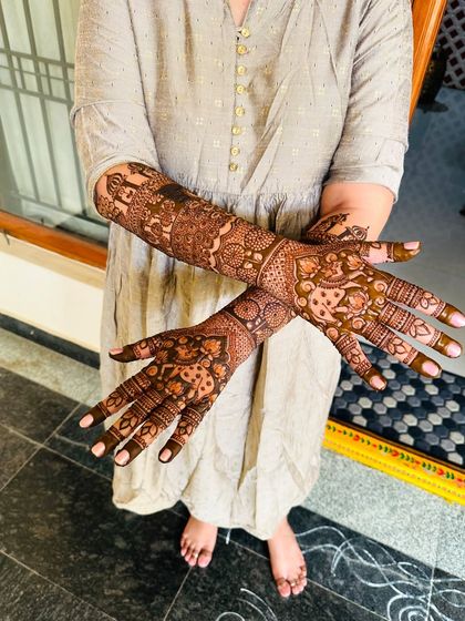 This bride chose a full coverage design with elephants and peacocks, extending from her hands down to her feet for a complete traditional look.