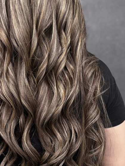 A close-up on the curls, showcasing the beautiful ribbons of blonde woven through the darker base color.