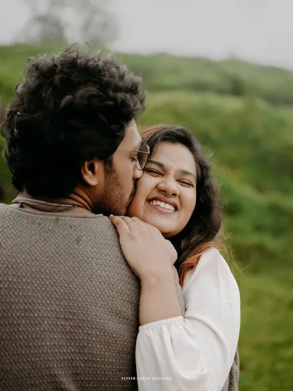 A tender kiss on the cheek, filled with genuine emotion and happiness. This candid moment is what makes a pre-wedding shoot so special.