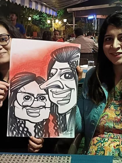 Two friends with their caricature, a great souvenir from their night out.