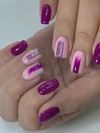 A beautiful purple manicure with glitter and brushstroke accents. This shows how you can add simple art to a single-color manicure to make it unique.