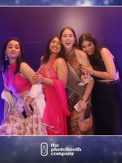 Friends celebrating together at Sanjana and Ishaan's cocktail party. Our booth provides a simple, elegant backdrop that lets the guests and their outfits shine.