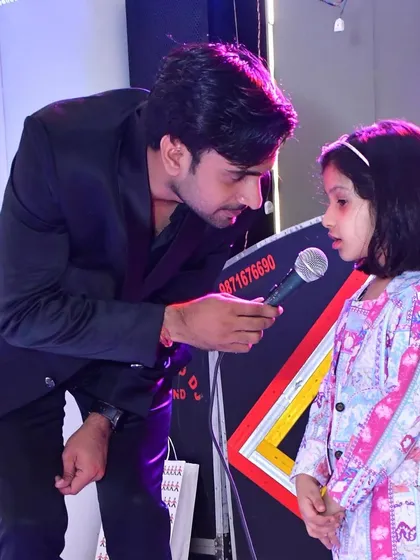 Interacting with a young volunteer on stage. I love bringing kids into the act to create a special, memorable moment for them.