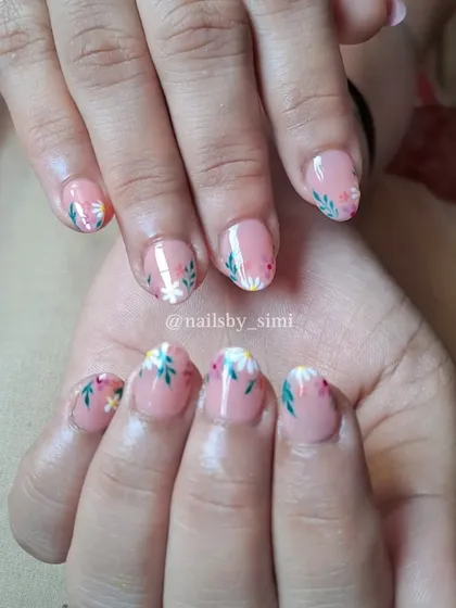 Floral tips on short, bitten nails. This shows that you can have beautiful nail art no matter your nail length!