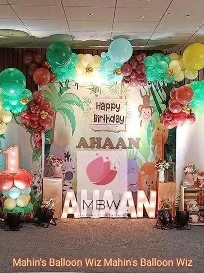 A closer look at the jungle party stage, highlighting the marquee letters and the variety of animal characters that bring the theme to life.