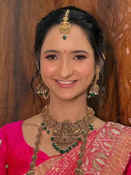 A happy, smiling portrait of Dhwani. Her makeup is radiant and natural, letting her joy be the centerpiece of the look.