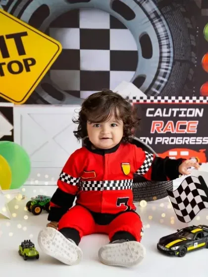 Waving the checkered flag to celebrate turning one! This little guy is having so much fun in the driver's seat.