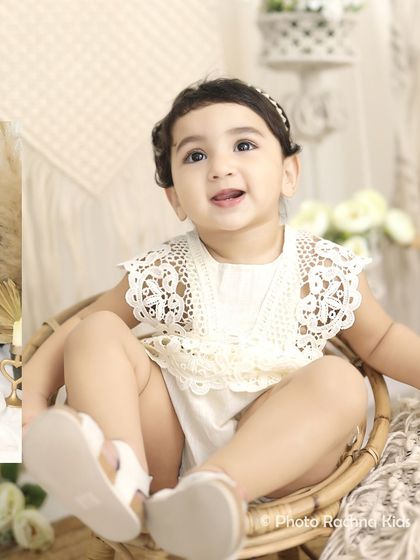 A close-up from our bohemian-themed photoshoot, featuring a toddler in a lovely lace outfit sitting in a wicker chair.