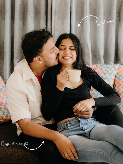 Opposites attract: he's coffee at midnight, she's tea at dawn. This playful shot captures their different personalities coming together in a sweet, affectionate moment at home.