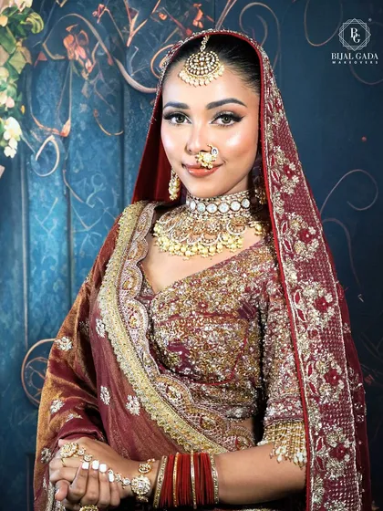 A confident and radiant bride ready for her big day. The makeup is bold yet elegant, with sharp, defined eyes and a perfectly matched base that enhances her features beautifully.