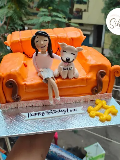 I'll be there for you. A detailed, fully sculpted cake of the iconic orange couch from "Friends," complete with a custom figurine and her adorable dog.
