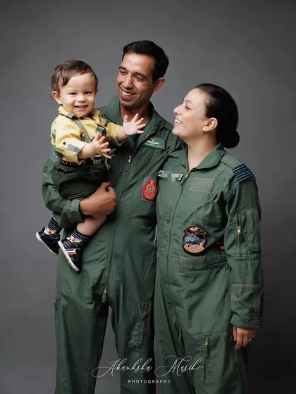 A candid moment of interaction within the Airforce family. The shared smiles and loving gazes tell a story of a close-knit and happy family.