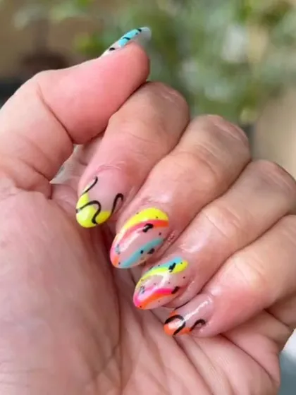 This fun and vibrant abstract nail art shows how I can play with bright neon colors and freehand black swirls for a unique, eye-catching manicure.