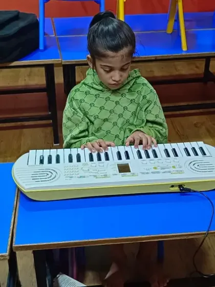 Three young students, each on their own keyboard, focused and learning together. Our group classes for kids encourage peer learning and make practice a shared, fun activity.