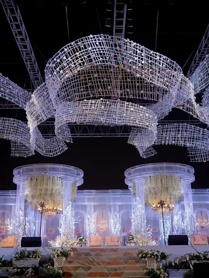 A close-up of the massive, ribbon-like ceiling installation made of a crystal-like material. This custom structure was designed to float above the reception stage, creating a sense of wonder.