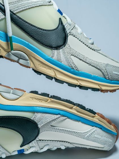 A top-and-bottom view of the Nike Zoom Vomero 5, showcasing its layered design and durable outsole.