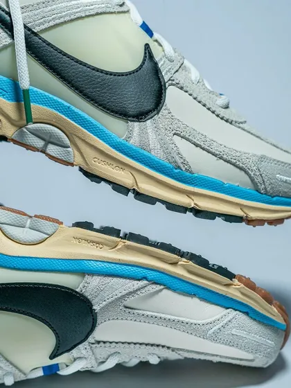 A top-and-bottom view of the Nike Zoom Vomero 5, showcasing its layered design and durable outsole.