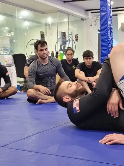 A close-up of the triangle choke demonstration from the seminar. The details are everything.