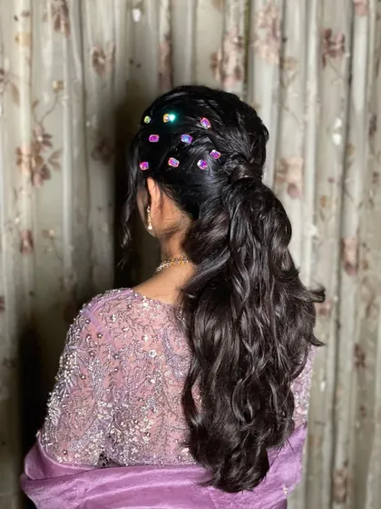 A side view of the crystal-adorned ponytail. The placement of the crystals adds a beautiful, scattered sparkle effect to the hair.