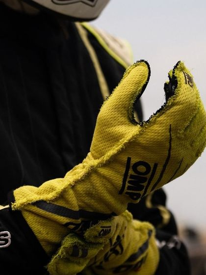The worn out glove of a driver tells a story of dedication, countless laps, and the physical effort required to control a high performance kart.