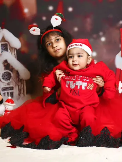 A festive Christmas photo featuring two siblings. I love capturing interactions between siblings during my themed shoots.