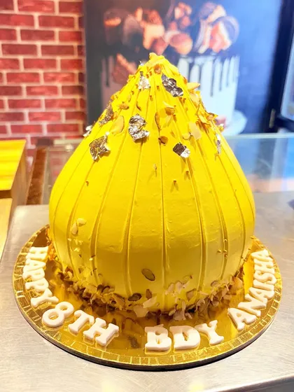 A unique cake shaped like a traditional Modak for an 18th birthday, combining tradition with modern celebration.