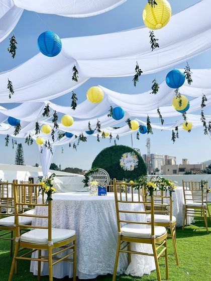 A beautiful outdoor brunch setup for Katya's Amalfi-themed birthday. We used a white canopy with blue and yellow lanterns to create a breezy, Mediterranean feel.