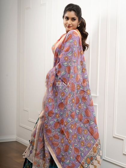 Discover the beauty of traditional craftsmanship with this stunning Pen Kalamkari lehenga. The piece is meticulously hand-painted by my artisans, with a story unfolding on the blouse sleeves and a beautiful floral pattern on the skirt and dupatta.