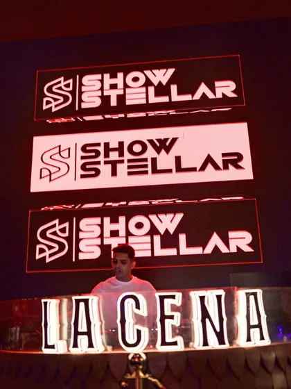 My branding front and center at La Cena. The visuals are a huge part of my show's identity.
