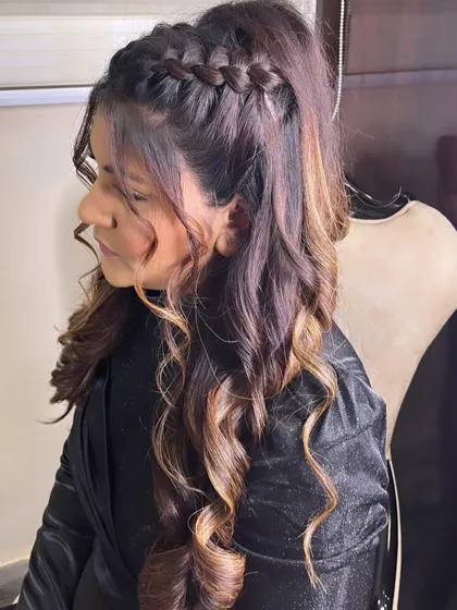 A half-up ponytail with a Dutch braid detail. This adds a lovely texture and interest to the hairstyle, making it perfect for a party.
