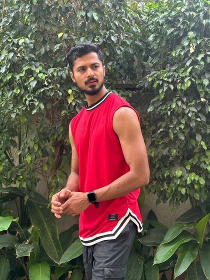 A casual athletic look with a red sleeveless top, perfect for a sportswear or lifestyle brand.