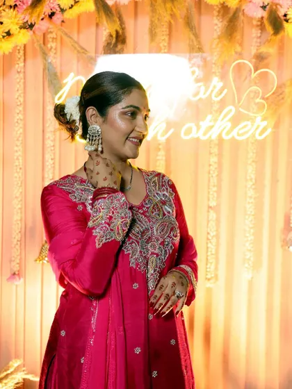 A side profile showing the beautiful embroidery on the sleeves and the elegant hairstyle. Every detail matters in creating a complete look.